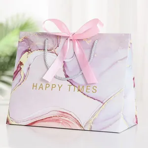 Pink marble gift bag with pink ribbon bow and silver handles, main view product presentation