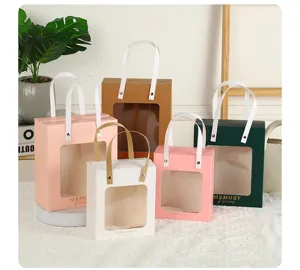 Detailed view of colorful macaron window gift bags with transparent display and handles.