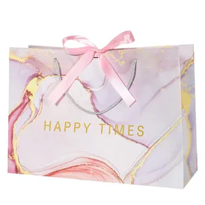 Elegant gift paper bag with pink bow ribbon, marble pattern decorative handbag for party favors.