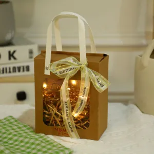 Kraft paper gift bag with clear window and ribbon bow, perfect for birthday party favors and wedding gifts.