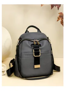 Fashionable gray oxford cloth backpack for women with gold hardware and stylish design.