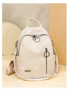 Classic beige soft leather women's backpack with chic ring zip details for daily use.