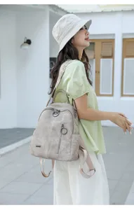 Side lifestyle view of retro soft leather women backpack displaying large daily capacity.