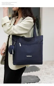 Women's nylon shoulder bag with top handle, spacious capacity and front zipper pocket.