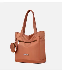Detailed view of the brown nylon shoulder tote bag featuring front zip pocket and mini pouch.