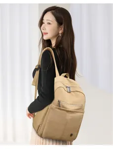 Lightweight nylon women backpack detail, casual large capacity travel rucksack design.