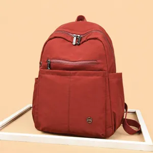 Stylish nylon casual backpack for women, large capacity travel school bag in red color.