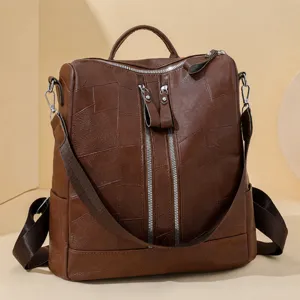 Sac à dos rétro en cuir PU pour femme avec fermetures éclair verticales pour voyage.