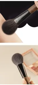 Walnut handle makeup brush with soft bristles for professional blush and powder application.