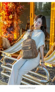 Outdoor detail view of the casual brown leather backpack, showcasing front pockets and texture.