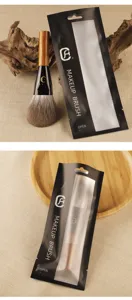 Professional makeup brush with wood handle and soft bristles for face powder application.