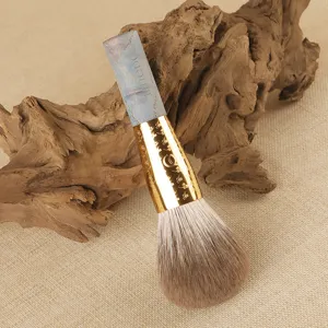 Large fluffy loose powder makeup brush with blue fox hair, wooden handle and gold ferrule