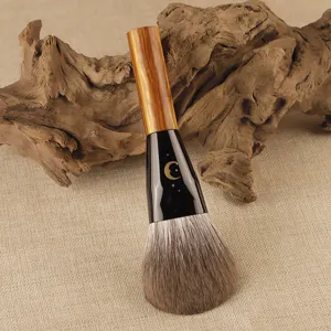 Professional flat powder brush with soft bristles and celestial moon design for flawless makeup.