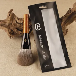 Professional makeup brush with soft bristles and wooden handle for smooth powder application.