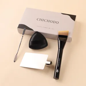 Professional makeup brush set with angled foundation brush, metal spatula, puff, and palette.
