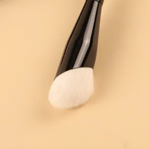 Professional angled foundation makeup brush with soft white hair and sleek black handle.