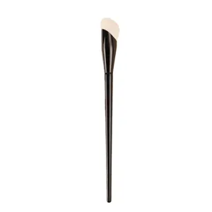 Professional makeup brush with angled bristles and black handle for flawless foundation application.