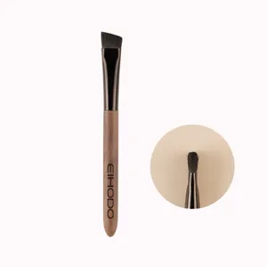 Professional angled eyebrow brush with wooden handle for precise makeup application and shaping.