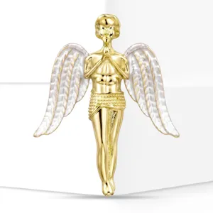 Macro view of elegant golden praying angel brooch with textured silver enamel wings