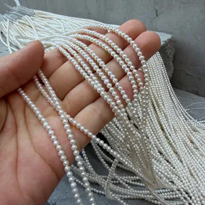 Vista dettagliata di fili di mini perle naturali d'acqua dolce da 2-3mm per gioielleria.