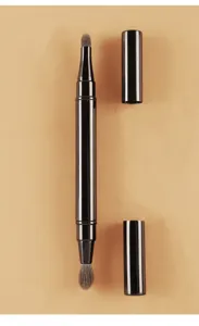 Detailed close-up view of the double-ended portable makeup brush with black caps.