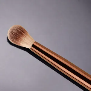 Professional makeup highlighter brush with thickened rose gold aluminum ferrule for precise application.