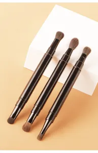 Double ended retractable makeup brush detail view showing dual brush heads for smooth eye shadow.