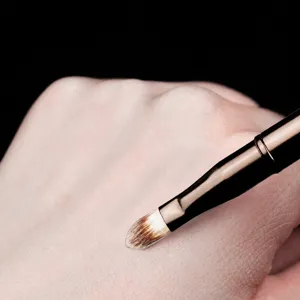 Portable dual-ended retractable lip brush with cap, synthetic hair makeup tool for blending.