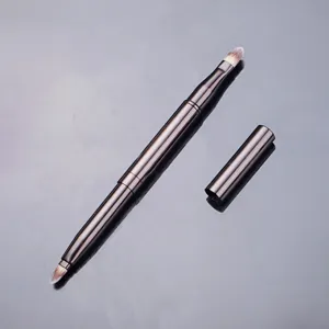 Professional double-ended retractable makeup brush with protective cap for portable cosmetic use.