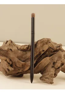 Eye blending makeup brush with natural animal hair and sleek black handle for precision shadow.