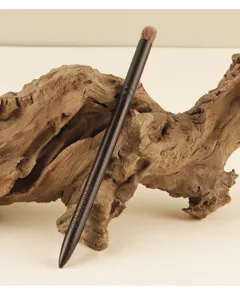 Detailed view of the black animal hair eye blending brush with wooden handle for makeup.