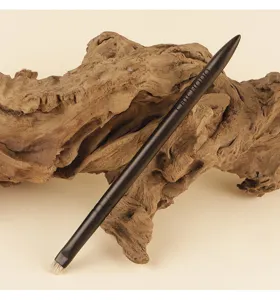 Detailed view of angular eyeliner and brow brush featuring soft bristles and dark handle.