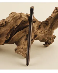 Detailed view of the angled eyebrow brush with animal hair and dark handle for precise makeup.