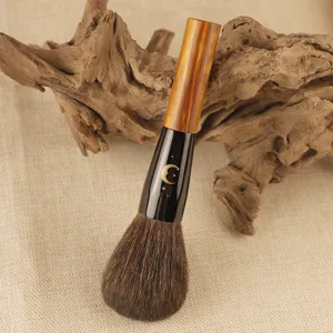 Round powder brush with wooden handle and star moon pattern for smooth makeup application main