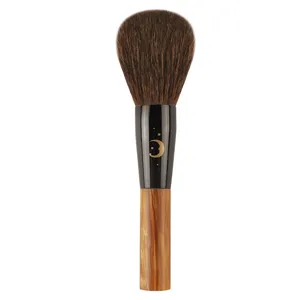Professional makeup powder brush with soft bristles, wooden handle and cute moon star design.