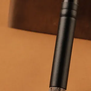 Professional eye makeup brush featuring a matte black handle and durable copper ferrule.