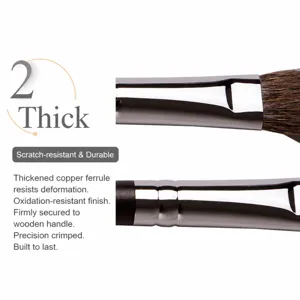 Professional makeup brush detail view featuring thickened copper ferrule and solid wood handle.