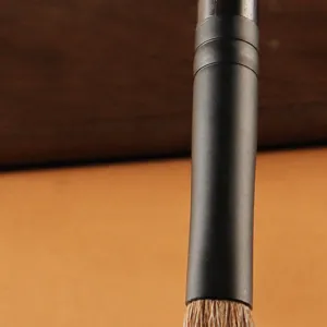 Pro eyeshadow makeup brush with matte copper ferrule for smooth blending and precise application.