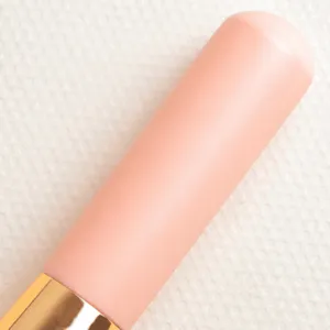 Pink makeup brush handle with smooth wooden grip and golden ferrule for daily cosmetic use.