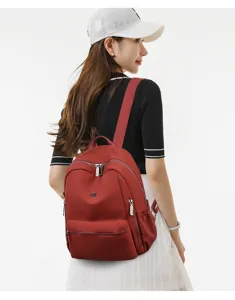 Red casual backpack detail view showing back carrying effect with model, clean and stylish design.