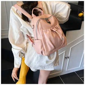 Stylish pink leather backpack for women, casual travel daypack with large capacity.