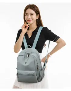 Closeup detail view of the casual minimalist fashion backpack worn by model, showing straps.