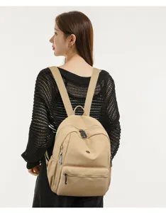 Casual minimalist women's backpack in solid beige color with multiple secure zip compartments.