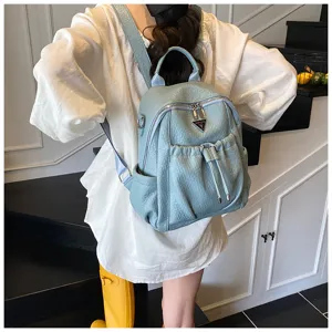 Fashionable light blue leather backpack for women, casual travel daypack with front pocket.