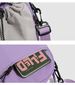 Detail view of a mountain style mini crossbody phone bag with adjustable strap and zipper pocket.