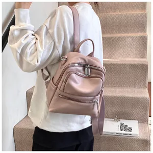 Detail shot of a stylish pink leather women casual backpack showcasing fine zipper and straps.