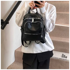 Black PU leather casual backpack for women, multi-zipper stylish school travel bag.