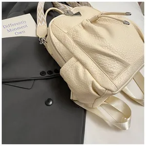 Stylish cream white faux leather mini backpack with drawstring and wide straps for women.