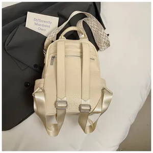 Detailed shot of women's beige leather backpack with wide straps and back zipper pocket.