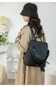 Close-up detail view of stylish black leather backpack for women commuting daily use.